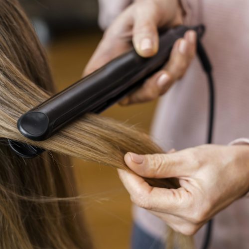 woman-getting-her-hair-straightened-home